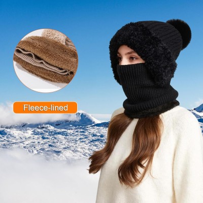 Woman wearing a knitted fleece lined balaclava as hooded beanie and neck warmer in snowy winter