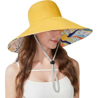 Woman wearing a reversible wide brim sun hat with UPF50+ protection at the beach