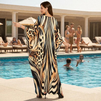 Plus size woman wearing bohemian maxi kaftan dress as swim cover up and loungewear