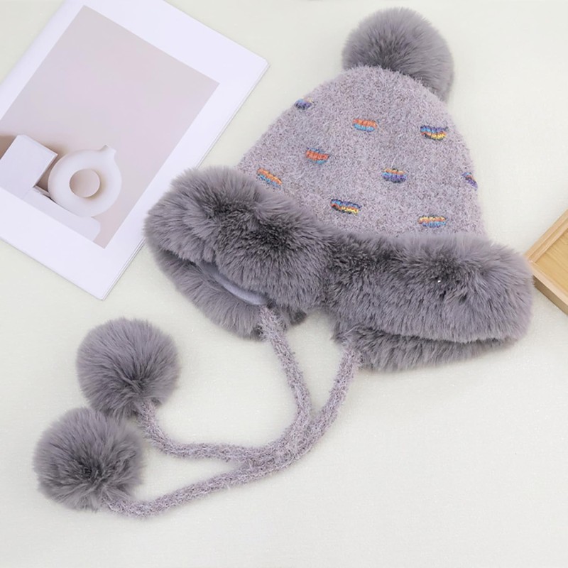 Women's gray knit winter ponytail beanie with sherpa lining, ear flaps, and 3 pompoms