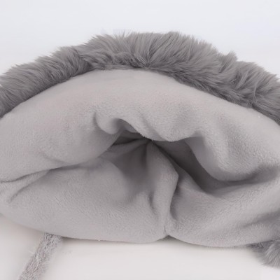 Women's gray knit winter ponytail beanie with sherpa lining, ear flaps, and 3 pompoms