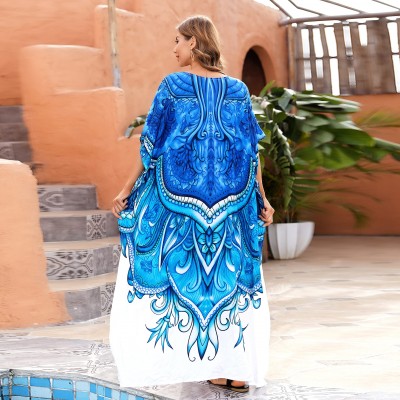 Woman wearing plus size kaftan dress as beach cover up with bohemian floral print