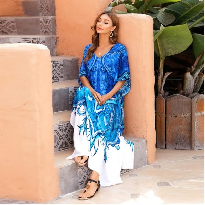 Woman wearing plus size kaftan dress as beach cover up with bohemian floral print