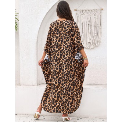 Bohemian Leopard Caftan Dress Coverup Plus size woman wearing bohemian leopard print caftan dress as swim coverup on beach