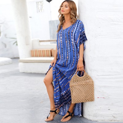 Blue Plus Size And Flowy Kaftan Dress – Women's Bohemian Beach Cover Up Woman in blue arrow and stripe pattern kaftan dress with batwing sleeves and V-neck on beach