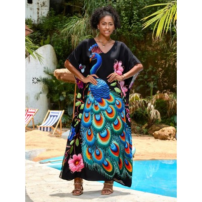 Tropical Bohemian Kaftan Dress with Peacock Print Woman in black floral print V-neck kaftan dress by pool