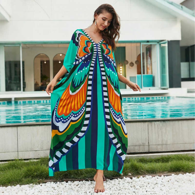 Bohemian Ethnic Print Kaftan Dress – Women's Poolside Cover Up & Loungewear Woman in colorful bohemian ethnic print kaftan dress with batwing sleeves and V-neck standing by a pool