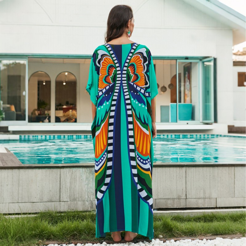 Bohemian Ethnic Print Kaftan Dress – Women's Poolside Cover Up & Loungewear Woman in colorful bohemian ethnic print kaftan dress with batwing sleeves and V-neck standing by a pool