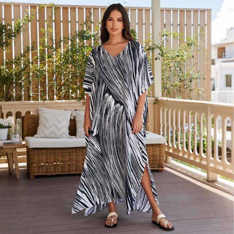 Bohemian Abstract Striped Caftan Dress: Women's Beach Cover Up Woman in bohemian abstract striped caftan dress with batwing sleeves and V-neck on beach