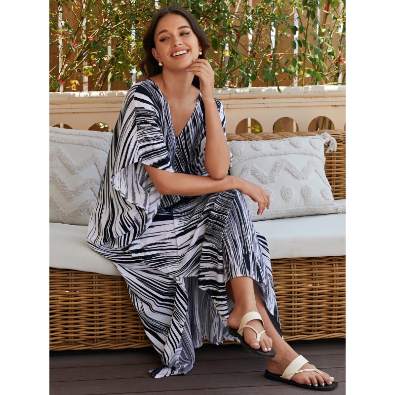 Bohemian Abstract Striped Caftan Dress: Women's Beach Cover Up Woman in bohemian abstract striped caftan dress with batwing sleeves and V-neck on beach