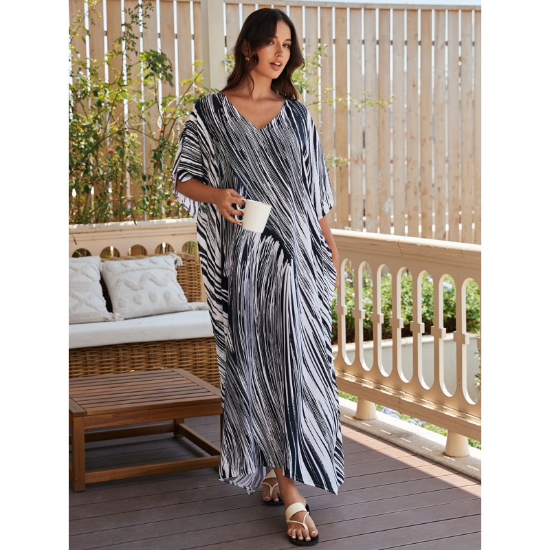 Bohemian Abstract Striped Caftan Dress: Women's Beach Cover Up Woman in bohemian abstract striped caftan dress with batwing sleeves and V-neck on beach