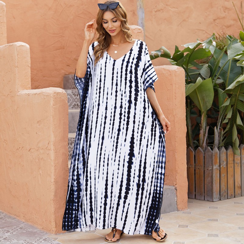 Black and White Striped Caftan Dress: Plus Size Beach Cover Up for Women Woman in black and white striped plus size caftan dress with V-neck