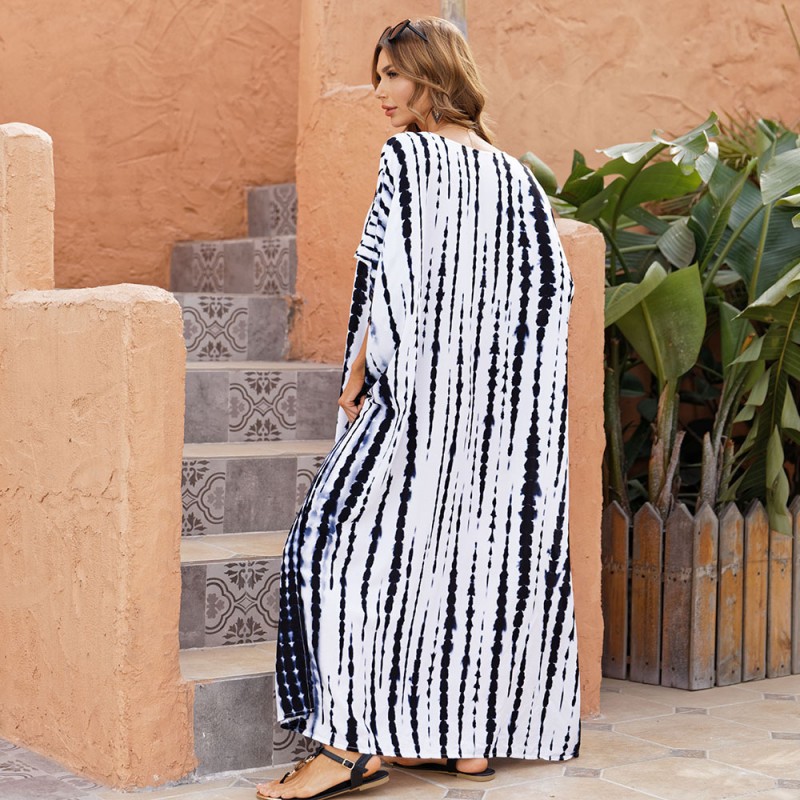 Black and White Striped Caftan Dress: Plus Size Beach Cover Up for Women Woman in black and white striped plus size caftan dress with V-neck