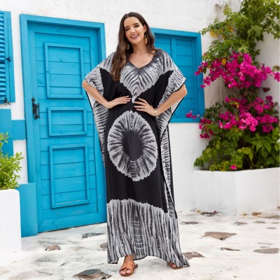 Bohemian Abstract Art Print Caftan Dress: Women's Beach Cover Up with Batwing Sleeves Woman in black and white bohemian abstract art print caftan dress with batwing sleeves and V-neck standing in front of blue door