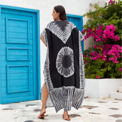 Bohemian Abstract Art Print Caftan Dress: Women's Beach Cover Up with Batwing Sleeves Woman in black and white bohemian abstract art print caftan dress with batwing sleeves and V-neck standing in front of blue door