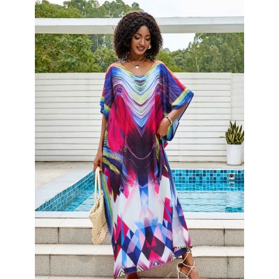 Colorful Tie-Dyed Kaftan Dress for Women Woman in colorful tie-dyed women's kaftan dress with V-neck and batwing sleeves by a pool