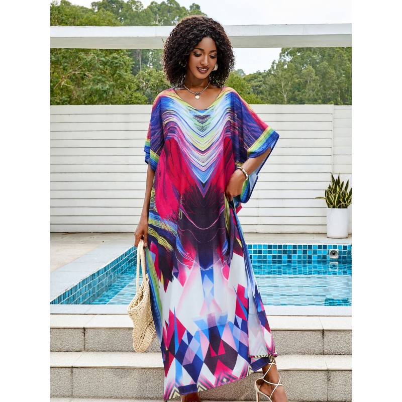 Colorful Tie-Dyed Kaftan Dress for Women Woman in colorful tie-dyed women's kaftan dress with V-neck and batwing sleeves by a pool