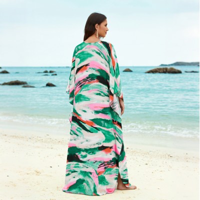 Plus Size Caftan Dress Women’s Beach Cover Up with Vibrant Print Woman in plus size caftan dress with vibrant green pink print standing on beach