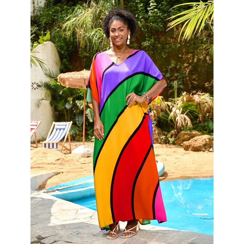 Plus Size Rainbow Stripe Kaftan Maxi Dress – Summer Beachwear Woman in a rainbow striped V neck kaftan maxi dress standing by a pool