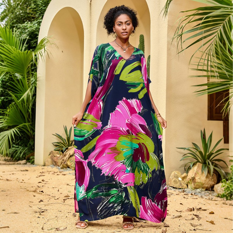 Woman wearing colorful bohemian V neck kaftan maxi dress by the pool   