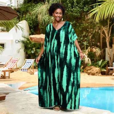 Green Abstract Print Caftan Maxi Dress – Boho Resort Cover Up Woman in green abstract stripe caftan maxi dress standing poolside