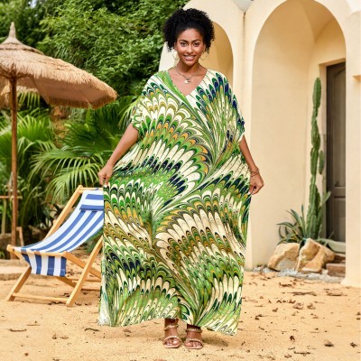 Feather Print Caftan Maxi Dress – Bohemian Resort Outfit in Green Woman wearing feather print caftan maxi dress with green abstract pattern