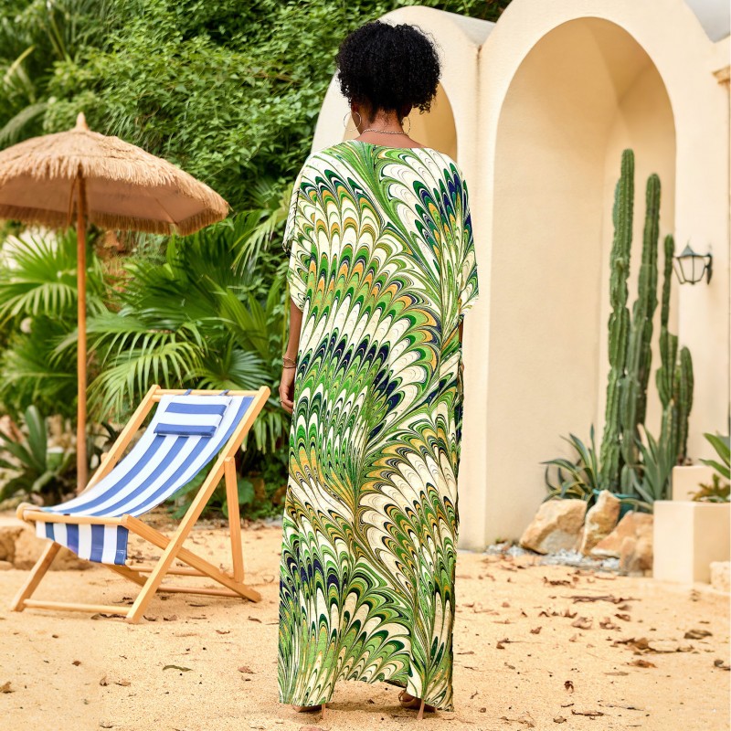 Feather Print Caftan Maxi Dress – Bohemian Resort Outfit in Green Woman wearing feather print caftan maxi dress with green abstract pattern